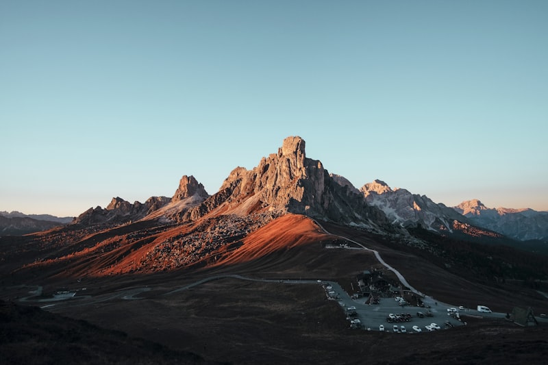 Dusty gravel road leading through pine trees toward a lake in Ontario cottage country